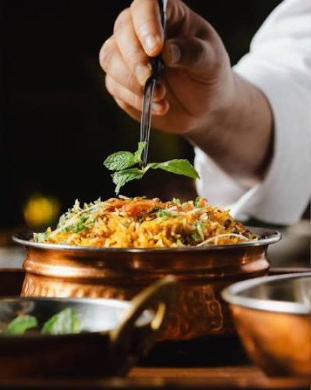 Master chef preparing traditional Hyderabadi biryani